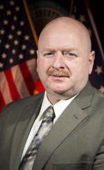 man wearing tie, american flag background